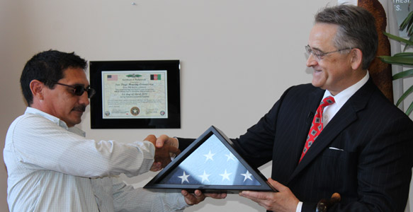 <span>Thank You & Patriotic Gesture</span><br>Navy Seabee reservist and former Housing Commission maintenance worker Edmundo Galvan, left, presents a U.S. flag flown over Kandahar during his tour in Afghanistan to Housing Commission President and CEO Richard C. Gentry on June 30, 2010. Read News Release